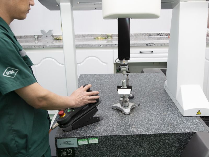 A worker is operating the test machine for trilinear coordinates test.