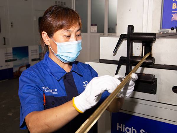 Our quality inspector is checking the diameter of the hydraulic hose.