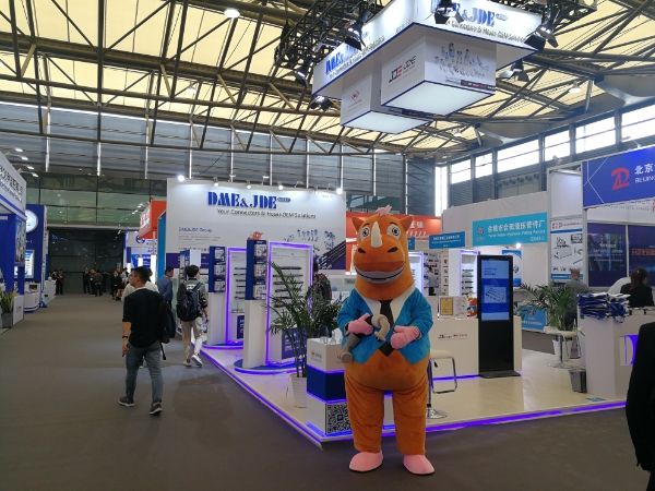 The mascot of DME&JDE is standing in the exhibition hall.